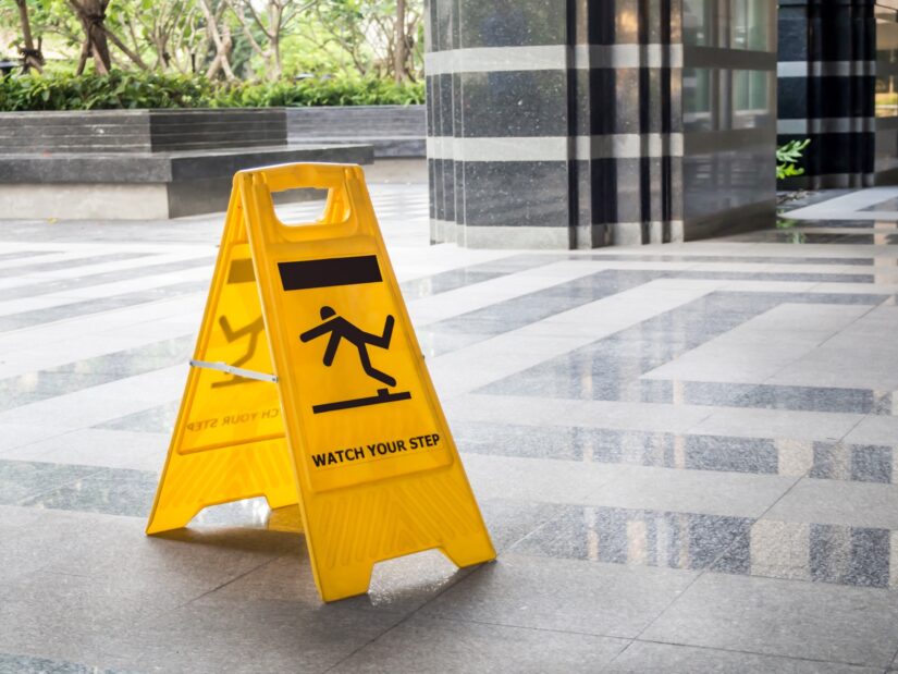 photo of slippery sign on the floor