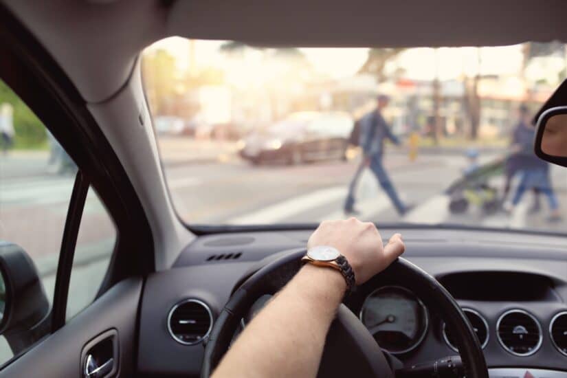 photo of driver in the car watching over road