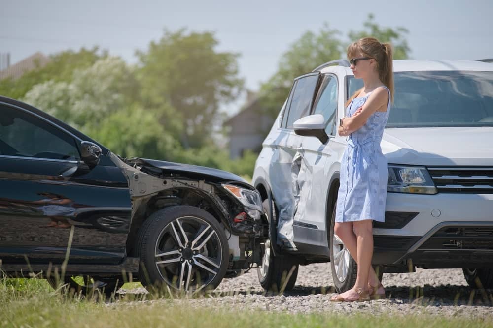 Woman Standing Beside A T-Bone Accident